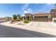 Well-maintained home featuring desert landscaping, a two-car garage, and a neutral color palette at 17664 W Marshall Ln, Surprise, AZ 85388