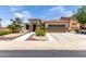 Beautiful single-story home featuring a well-manicured landscape, stone accents, and a tile roof at 17664 W Marshall Ln, Surprise, AZ 85388