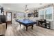 Spacious game room with a ping pong table, brick accent wall, and natural light at 17664 W Marshall Ln, Surprise, AZ 85388
