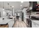 Bright and airy kitchen featuring a long countertop and view of the game room and breakfast nook at 17664 W Marshall Ln, Surprise, AZ 85388