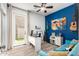 Bright home office with accent wall, modern desk, and large window showcasing the backyard at 17664 W Marshall Ln, Surprise, AZ 85388