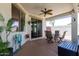 Covered patio features decorative ceiling fan, neutral color scheme, and sliding glass doors at 17664 W Marshall Ln, Surprise, AZ 85388