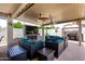 Luxurious outdoor space features multiple seating areas, ceiling fans, and outdoor kitchen at 17664 W Marshall Ln, Surprise, AZ 85388