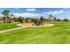 Community playground with a variety of play equipment and green space for outdoor activities at 17664 W Marshall Ln, Surprise, AZ 85388