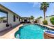 The backyard oasis has a pool and a relaxing outdoor living space for entertaining at 17664 W Marshall Ln, Surprise, AZ 85388