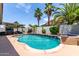 Inviting pool area features a relaxing spa, tropical landscaping and covered outdoor seating at 17664 W Marshall Ln, Surprise, AZ 85388