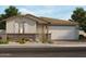 Inviting single-story home showcasing charming desert landscaping and a two-car garage at 17840 W Pierson St, Goodyear, AZ 85395