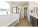 Bright bathroom features a glass shower enclosure and a separate soaking tub at 19028 W Rose Ln, Waddell, AZ 85355