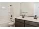 Bright bathroom with a double sink vanity, bathtub and modern fixtures at 19028 W Rose Ln, Waddell, AZ 85355