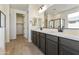 Modern bathroom with double vanity, quartz countertop, and sleek black fixtures at 19028 W Rose Ln, Waddell, AZ 85355