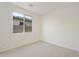 Neutral bedroom features a large window providing ample natural light and great views at 19028 W Rose Ln, Waddell, AZ 85355