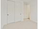 Bright bedroom featuring plush carpet, white walls, and closet with sliding doors at 19028 W Rose Ln, Waddell, AZ 85355