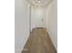 Bright hallway with white walls and sleek tile flooring leads to a welcoming interior at 19028 W Rose Ln, Waddell, AZ 85355