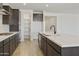 Open kitchen featuring white countertops, gas stove, walk-in pantry, and dark wood cabinets providing plenty of storage at 19028 W Rose Ln, Waddell, AZ 85355