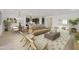 Spacious living area featuring modern decor and an open layout connecting the living, dining, and kitchen spaces at 19028 W Rose Ln, Waddell, AZ 85355
