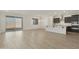 Bright living area flows into a modern kitchen, featuring tile floors and sliding glass doors to the backyard at 19028 W Rose Ln, Waddell, AZ 85355