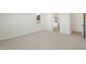 Bright primary bedroom with a neutral carpet and a view to the en-suite bathroom at 19028 W Rose Ln, Waddell, AZ 85355