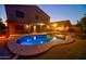 Backyard pool at dusk with covered patio, outdoor furniture, and well-maintained landscaping at 2008 N Pablo Ct, Casa Grande, AZ 85122