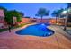 Backyard pool featuring a basketball hoop, desert landscaping, covered patio with outdoor seating at 2008 N Pablo Ct, Casa Grande, AZ 85122