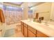 Well-lit bathroom features double sinks, wood cabinets, and shower/tub combo at 2008 N Pablo Ct, Casa Grande, AZ 85122