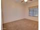 Clean, well-lit bedroom with neutral carpet, ceiling fan, and a window with blinds at 2008 N Pablo Ct, Casa Grande, AZ 85122