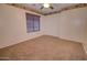 Bright bedroom featuring neutral carpet, ceiling fan, and window with wood blinds at 2008 N Pablo Ct, Casa Grande, AZ 85122