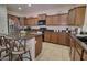 Spacious kitchen featuring granite countertops, center island with bar stools, and stainless appliances at 2008 N Pablo Ct, Casa Grande, AZ 85122