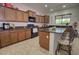 Beautiful kitchen featuring granite countertops, a central island with bar seating, and ample cabinetry at 2008 N Pablo Ct, Casa Grande, AZ 85122