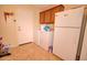 Functional laundry area with washer, dryer, and ample storage space, blending convenience and utility at 2008 N Pablo Ct, Casa Grande, AZ 85122