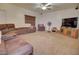Comfortable living room with plush seating, a ceiling fan, and entertainment center for relaxation at 2008 N Pablo Ct, Casa Grande, AZ 85122