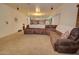 Spacious living area with open layout, sectional sofa, and seamless flow into the kitchen and dining area at 2008 N Pablo Ct, Casa Grande, AZ 85122