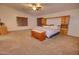 Spacious main bedroom featuring an ensuite bath, ceiling fan, and beautiful natural light at 2008 N Pablo Ct, Casa Grande, AZ 85122