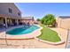 Beautiful backyard with pool, artificial turf, and lush, mature landscaping at 2008 N Pablo Ct, Casa Grande, AZ 85122