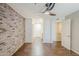 Bedroom featuring brick wall, hardwood floors, ceiling fan and white doors at 2025 E Campbell Ave # 143, Phoenix, AZ 85016