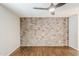 Bedroom features hard flooring, brick wall and new paint at 2025 E Campbell Ave # 143, Phoenix, AZ 85016