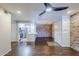 Open-plan living area featuring a kitchen with stainless steel appliances and brick accent wall at 2025 E Campbell Ave # 143, Phoenix, AZ 85016