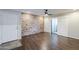 Inviting living room featuring a brick wall, ceiling fan, and wood flooring at 2025 E Campbell Ave # 143, Phoenix, AZ 85016