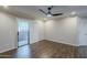 Bright living room with wood floors and sliding glass doors leading to a balcony at 2025 E Campbell Ave # 143, Phoenix, AZ 85016