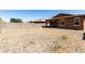 Large backyard with a block wall fence, and desert rock ground covering at 2176 W Larissa Ln, San Tan Valley, AZ 85144