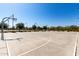 Community basketball court with lighting and well-maintained surface for recreational activities at 2176 W Larissa Ln, San Tan Valley, AZ 85144
