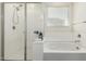Bright bathroom showcasing walk-in shower, soaking tub, and window at 2176 W Larissa Ln, San Tan Valley, AZ 85144