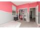 View of the bedroom with half pink walls, half grey walls, open closet, and a window at 2176 W Larissa Ln, San Tan Valley, AZ 85144