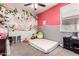 A charming bedroom with colorful floral mural, carpet flooring, and a playful atmosphere at 2176 W Larissa Ln, San Tan Valley, AZ 85144