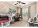 Well-lit room with a ceiling fan, large window with curtains, and many crafting machines at 2176 W Larissa Ln, San Tan Valley, AZ 85144