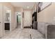 Bright entryway with neutral tile floors, a modern grey sofa, and views into the home's interior at 2176 W Larissa Ln, San Tan Valley, AZ 85144