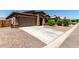 Front exterior view of this lovely home, boasting a two-car garage and well-kept desert landscape at 2176 W Larissa Ln, San Tan Valley, AZ 85144