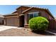 Close exterior shot highlighting the stone veneer, desert landscaping, and charming window shutters at 2176 W Larissa Ln, San Tan Valley, AZ 85144