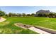 This green space has luscious green grass, trees, and a shaded structure at 2176 W Larissa Ln, San Tan Valley, AZ 85144