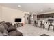 Spacious living room with tile flooring and open access to the kitchen and dining areas at 2176 W Larissa Ln, San Tan Valley, AZ 85144