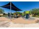 A large playground with modern equipment and a sunshade offers outdoor fun for residents in this community at 2176 W Larissa Ln, San Tan Valley, AZ 85144